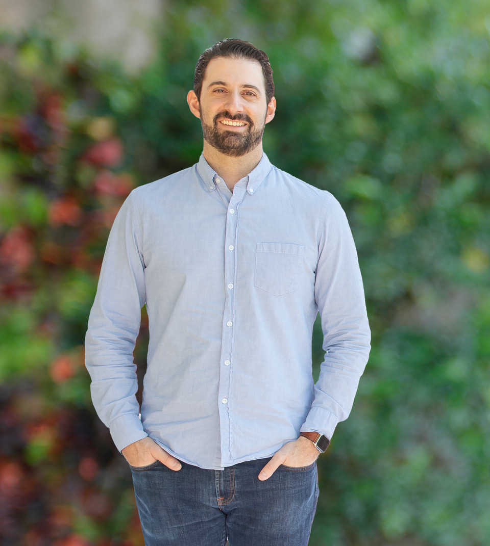 Professional portrait of Dr. Joshua Jaffe, General Dentist, showcasing his expertise with a backdrop of blurred outdoor scenery in Hollywood, Florida.